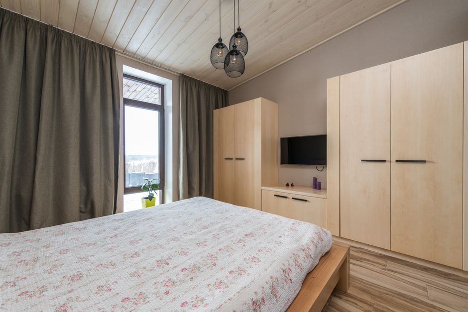 Inviting bedroom showcasing modern interior design with warm wooden elements and natural light.
