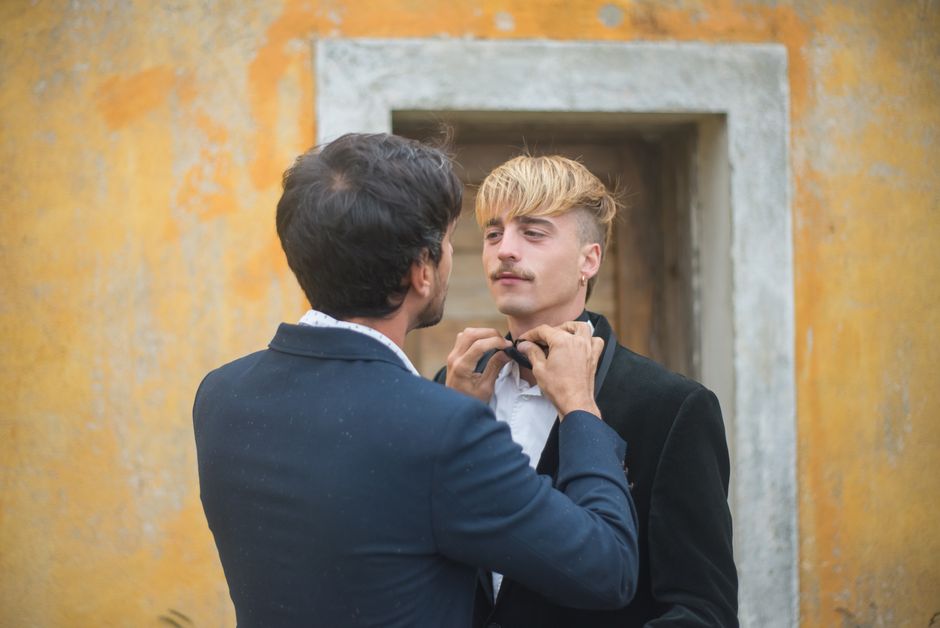 Two men preparing for a wedding day in Portugal, showcasing love and commitment.