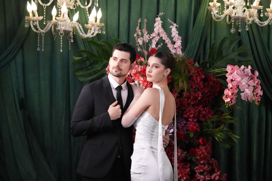 Sophisticated couple posing at a wedding event in Jakarta with stunning floral decorations.