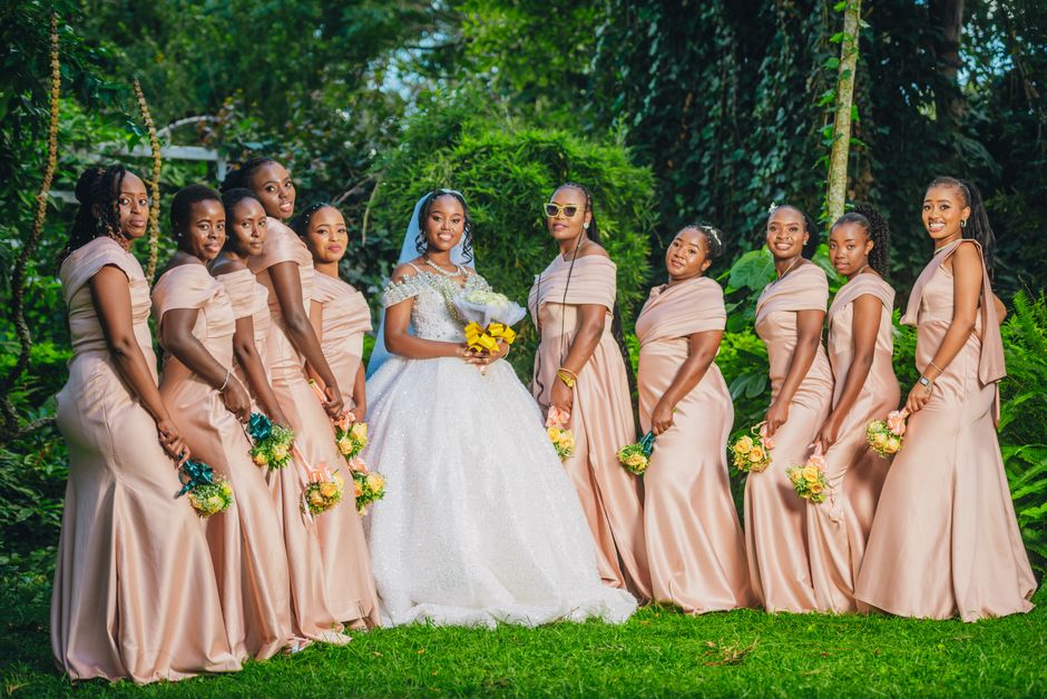 Elegant bridal party in soft pink dresses poses with bride in Rungiri, Kenya.