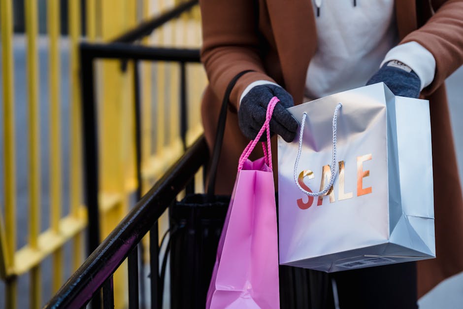 A stylish woman holding shopping bags from a city sale, showcasing modern urban lifestyle.