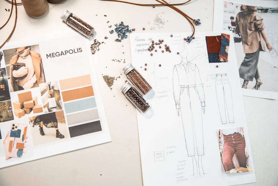 Creative fashion workspace featuring design sketches, mood boards, and beads on a desk.